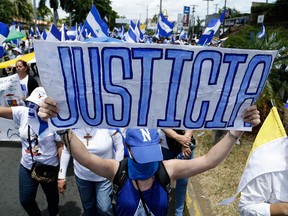 An anti-government demonstrator takes part in a march demanding the resignation of President Daniel Ortega and the release of all political prisoners, in Managua, Nicaragua, on July 28, 2018.