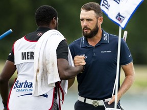 FILE - In this July 20, 2018, file photo, Troy Merritt celebrates with caddie Wayne Burch on the 18th green after completing the second round of the PGA Tour's Barbasol Championship golf tournament at Keene Trace Golf Club in Nicholasville, Ky. Merritt shot 5-under 67 to edge three golfers by one shot on Monday, July 23, 2018, and win the rain-delayed PGA Tour Barbasol Championship.