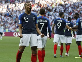 FILE - In this Saturday, June 30, 2018 file photo, France's Kylian Mbappe celebrates after scoring his side's third goal during their round of 16 match against Argentina, at the 2018 soccer World Cup at the Kazan Arena in Kazan, Russia. Kylian Mbappe and Thierry Henry are seemingly linked by destiny. While Henry is France's leading scorer with 51 goals and among the greatest forwards of the modern era, the 19-year-old Mbappe is the new French sensation tipped to become perhaps even the world's best.