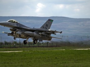 FILE - In this Thursday, April 10, 2014 file photo, a U.S-made F16 fighter jet takes off from an air base in Campia Turzii, Romania. The Slovak government on Wednesday, July 11, 2018 has approved a Defense Ministry plan to purchase 14 F-16 military jets from the United States. The fighter jets are meant to replace the obsolete Soviet-made MiG-29 jets that the Slovak air forces have used.