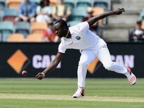 FILE - In this Thursday, Dec. 10, 2015 file photo, West Indies' bowler Kemar Roach fields off his own bowling against Australia during their cricket test match in Hobart, Australia. Bangladesh was all out for only 43 before lunch on the opening day as West Indies right-arm quick Kemar Roach destroyed the tourists with figures of 5-8 in the first test on Wednesday, July 4, 2018.