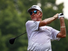 FILE - In this Sunday, May 20, 2018 file photo, Miguel Angel Jimenez tees off on the third hole during the final round of the Regions Tradition PGA Champions Tour golf tournament, in Birmingham, Ala. Miguel Angel Jimenez and Stephen Ames were sharing the lead on 9-under when darkness ended play early in the second round of the Senior British Open. Ames is among 18 players who must return on Saturday, July 28 to complete their rounds.