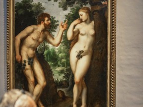 In this photo taken on Thursday, July 26, 2018, visitors look at the painting "Adam and Eve" by Flemish master Peter Paul Rubens in the Rubenshouse in Antwerp, Belgium. Belgian museums are uniting in protest against Facebook since they cannot promote Flemish masters like Rubens at will for falling foul of the social media site's adult content rules. Facebook says it has more restrictive rules when it comes to advertising which "must not contain adult content. This includes nudity, depictions of people in explicit or suggestive positions, or activities that are overly suggestive or sexually provocative."