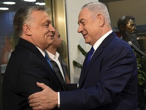 Hungarian Prime Minister Viktor Orban, left is welcomed by Israeli Prime Minister Benjamin Netanyahu upon his arrival, at the Prime Minister's office in Jerusalem, Thursday July 19, 2018.