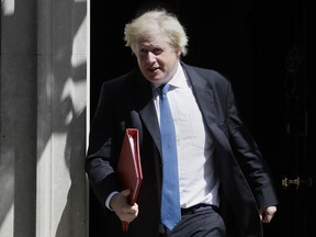 FILE- In this file photo dated Wednesday, June 13, 2018, Britain's Foreign Minister Boris Johnson leaves 10 Downing Street in London.  UK Foreign Secretary Boris Johnson has resigned Monday July 9, 2018, amid Cabinet splits over Brexit.