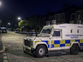 Police at the scene of an explosive device attack on the home of former Sinn Fein leader Gerry Adams, in West Belfast, Northern Ireland, early Saturday July 14, 2018. Northern Ireland's Sinn Fein says that the homes of former leader Gerry Adams and another prominent party member have been attacked with explosive devices on Friday Night. No one was injured.