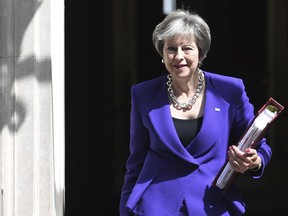 Britain's Prime Minister Theresa May leaves 10 Downing Street in London, bound for the House of Commons to face Prime Minister's Questions, Wednesday July 4, 2018.