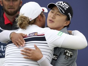 Korea's Amy Yang, right, hugs Thailand's Ariya Jutanugarn on the 18th hole after their round on day three of the Ladies Scottish Open at Gullane Golf Club, Scotland, Saturday July 28, 2018.