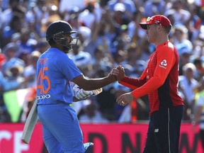 India's Rohit Sharma, left, shakes hands with England's Jason Roy at the end of the 3rd IT20 Series cricket match between England and India, at the Brightside Ground, in Bristol, England, Sunday July 8, 2018. India won by 7 wickets.