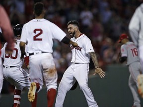 Boston Red Sox's Blake Swihart, right, is congratulated after his walk-off RBI double off Philadelphia Phillies relief pitcher Luis Garcia during the 13th inning of a baseball game at Fenway Park in Boston, Monday, July 30, 2018. The Red Sox defeated the Phillies 2-1.