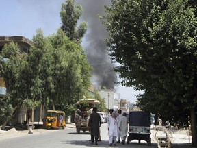 Smoke rises from a building after a deadly attack including a suspected suicide car bombing and gunbattles, in Jalalabad, Afghanistan, Tuesday, July 31, 2018. An Afghan provincial official said a coordinated attack was underway by the Taliban in the city of Jalalabad, the capital of eastern Nangarhar province. (AP Photo)