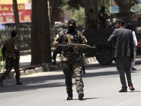 Security personnel patrol near a park where a would-be attacker was killed in Kabul, Afghanistan, Monday, July 16, 2018. A would-be suicide attacker was shot and killed by police in Kabul before he was able to get close to a gathering of supporters of the country's first vice president, Gen. Abdul Rashid Dostum, according to police spokesman Hashmat Stanekzai. Dostum is currently in Turkey.