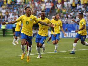 Brazil's Neymar, left, celebrates after scoring his side's opening goal during the round of 16 match between Brazil and Mexico at the 2018 soccer World Cup in the Samara Arena, in Samara, Russia, Monday, July 2, 2018.