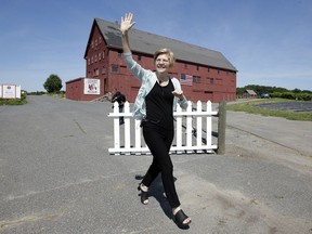 U.S. Sen. Elizabeth Warren, D-Mass., waves as she arrives at Belkin Family Lookout Farm before a town hall event, Sunday, July 8, 2018, in Natick, Mass. Warren is hosting the town hall and cookout following an Independence Day trip to visit U.S. troops in Iraq and Kuwait.