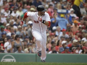 Boston Red Sox's J.D. Martinez runs after hitting an RBI-double off a pitch by Minnesota Twins' Jose Berrios in the second inning of a baseball game, Sunday, July 29, 2018, in Boston.