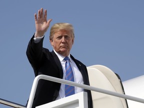 President Donald Trump waves as he boards Air Force One on Tuesday, July 3, 2018, at Andrews Air Force Base, Md.