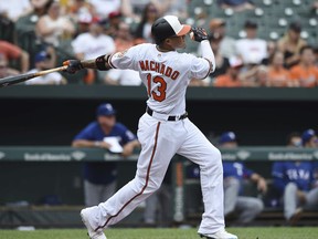 Baltimore Orioles' Manny Machado follows through on a solo home run against the Texas Rangers in the first inning of a baseball game, Sunday, July 15, 2018, in Baltimore.
