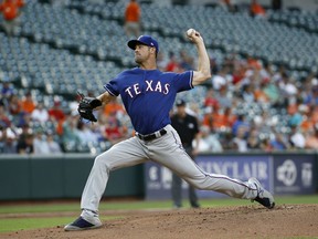 Texas Rangers starting pitcher Cole Hamels throws to the Baltimore Orioles in the first inning of a baseball game, Friday, July 13, 2018, in Baltimore.