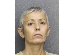 This Monday, July 16, 2018 photo made available by the Broward County Sheriff's Office, Fla., shows Gabriela Perero under arrest. Perero is accused of beating her 85-year-old mother to death after learning she wouldn't be receiving an inheritance from her. Police charged Perero with premeditated murder and aggravated battery on a person over 65. (Broward County Sheriff's Office via AP)
