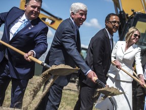 From left: Dwight Duncan, Michigan Gov. Rick Snyder, Amarjeet Sohi, and Kelly Craft shovel mounds of dirt during a ceremonial groundbreaking event for the Gordie Howe International Bridge in Detroit, Tuesday, July 17, 2018. The Canadian-financed span will connect Detroit with Windsor, Ontario. Currently, the privately-owned Ambassador Bridge and the Detroit-Windsor Tunnel are the only commuter crossings between the two cities.
