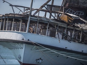 The SS Ste. Claire lists port side after catching fire at Detroit's Riverside Marina on Friday, July 6, 2018. The cause of the blaze wasn't immediately known. The SS Ste. Claire, once used to ferry passengers to an island amusement park, made her last run in 1991 and was designated a National Historic Landmark in 1992.