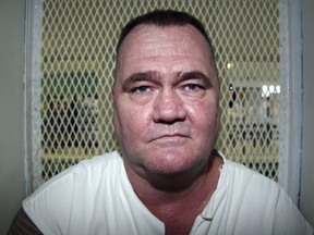 In this Aug. 29, 2012, file photo, convicted killer Cleve Foster speaks from a visiting cage at the Texas Department of Criminal Justice Polunsky Unit outside Livingston, Texas.