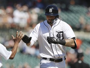 Detroit Tigers' Nicholas Castellanos is congratulated by the ballboy after hitting a solo home run during the first inning of a baseball game against the Texas Rangers, Saturday, July 7, 2018, in Detroit.