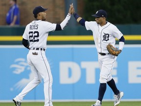 Detroit Tigers' Victor Reyes celebrates the team's 2-1 win over the Cleveland Indians with Leonys Martin after a baseball game Saturday, July 28, 2018, in Detroit.