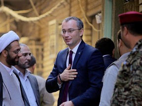 United Nations envoy to Iraq Nickolay Mladenov, center right, leaves the office of the top Shiite cleric, Grand Ayatollah Ali al-Sistani in Najaf,  after a meeting, 100 miles (160 kilometers) south of Baghdad, Iraq, Tuesday, March 3, 2015.