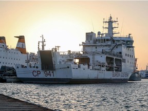 The Diciotti ship of the Italian Coast Guard, with 67 migrants on board rescued 4 days ago by the Vos Thalassa freighter, is moored in the Sicilian port of Trapani, southern Italy, Thursday, July 12, 2018. An Italian coast guard ship has docked in Sicily but is still awaiting permission to disembark its 67 migrants, after two of them were accused of threatening their rescuers if they were taken back to Libya.