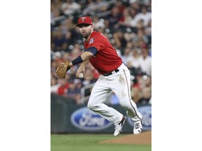 Minnesota Twins' Brian Dozier looks to throw the ball against the Cleveland Indians in the sixth inning of a baseball game Monday, July 30, 2018 in Minneapolis. Minnesota won 5-4.