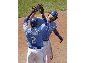 Kansas City Royals' Drew Butera (9) celebrates with Alcides Escobar after hitting a three-run inside-the-park home run during the seventh inning of a baseball game against the Minnesota Twins, Sunday, July 22, 2018, in Kansas City, Mo.