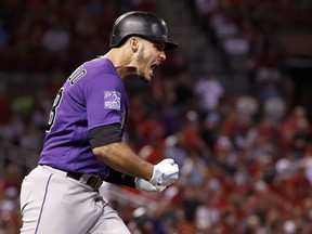 Colorado Rockies' Nolan Arenado celebrates after hitting a grand slam during the fifth inning of a baseball game against the St. Louis Cardinals Monday, July 30, 2018, in St. Louis.