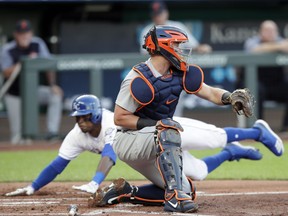Kansas City Royals' Rosell Herrera, back, beats the tag by Detroit Tigers catcher James McCann, front, during the first inning of a baseball game at Kauffman Stadium in Kansas City, Mo., Monday, July 23, 2018. Herrera and Whit Merrifield scored on a single by teammate Lucas Duda on the play.
