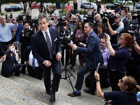 FILE - In this May 14, 2018 file photo, Gov. Eric Greitens leaves the civil courts building in St. Louis, Mo., after speaking with reporters after a felony invasion-of-privacy case against him was dismissed. In Missouri, Democratic lawmakers introduced a bill that would make clear that personal social media pages and messages sent through digital platforms such as Confide and Signal are public records as long as they relate to official business. The legislation arose because of a controversy involving use of the Confide app by Greitens, who resigned in June amid a series of scandals.