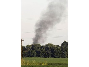 In this July 10, 2017 file photograph, smoke rises in the air after a KC-130T military transport plane crashed into a field near Itta Bena, Miss., on the western edge of Leflore County, as seen from U.S. Highway 82. The 15 Marines and Navy corpsman aboard, died. About 200 family members and friends are expected to attend the July 14, 2018 unveiling of a memorial built in their honor, across the street from Mississippi Valley State University in Itta Bena.