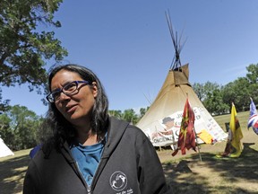 Robyn Pitawanakwat, a spokesperson for the Justice For Our Stolen Children camp, speaks with reporters following the announcement of an application against the government of Saskatchewan, the provincial capital commission and the Regina Police Service in Regina on Monday, July 16, 2018.