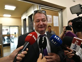 Former Jobbik party member and Hungarian Member of the European Parliament Bela Kovacs accused of spying on behalf of the Russian intelligence talks to reporters before the beginning of his trial on delivering internal information at a court in Budapest, Hungary, Tuesday, July 10, 2018.