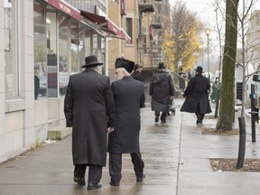 Hasidic Jews walk along Bernard Street in Outremont Wednesday, November 16, 2016 in Montreal.