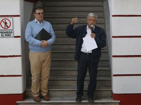 Mexico's President-elect Andres Manuel Lopez Obrador, right, and his future Foreign Minister, Marcelo Ebrard, speaks to the press outside his party's headquarters in Mexico City, Sunday, July 22, 2018. Lopez Obrador has released a seven-page letter he sent to U.S. President Donald Trump earlier in July detailing how he sees the two countries working together to stem immigration.