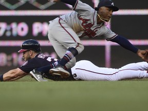 Washington Nationals' Bryce Harper, bottom, steals second base against Atlanta Braves second baseman Ozzie Albies, top, during the first inning of a baseball game at Nationals Park in Washington, Friday, July 20, 2018.