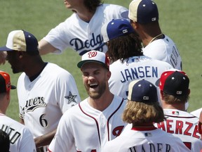 National League, Washington Nationals Bryce Harper, center, smiles as players mingle during a team photo, Monday, July 16, 2018, at Nationals Park, in Washington. The the 89th MLB baseball All-Star Game will be played Tuesday.