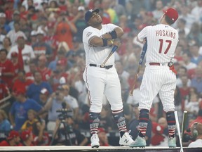 Milwaukee Brewers Jesús Aguilar, left, and Philadelphia Phillies Rhys Hoskins (17) face off before the MLB Home Run Derby, at Nationals Park, Monday, July 16, 2018 in Washington. The 89th MLB baseball All-Star Game will be played Tuesday.