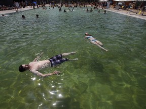 Members of the public float in the outdoor natural pool in Edmonton, Alta., on Monday, July 16, 2018. JORG XMIT: EDM101