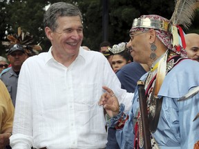 North Carolina Gov. Roy Cooper shares a laugh with Lumbee tribe member Jamie Oxendine during the American Indian Science and Engineering Society (AISES) Powwow during the 50th annual Lumbee Homecoming on the campus of UNC-Pembroke on Saturday July 7, 2018 in Pembroke, N.C. Cooper promised people in southern North Carolina he will do all he can to make sure they recover from flooding from Hurricane Matthew.