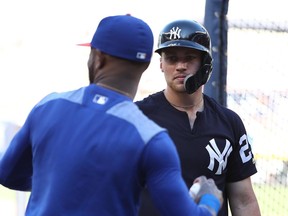 Brandon Drury of the New York Yankees greets Jose Reyes of the New York Mets before their game at Yankee Stadium on July 20, 2018.