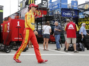 Joey Logano walks to his car in the garage at the start of practice for the NASCAR Cup Series auto race Saturday, July 21, 2018, at New Hampshire Motor Speedway in Loudon, N.H.