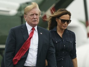 President Donald Trump and first lady Melania Trump walk from Marine One to board Air Force One at Morristown Municipal Airport, in Morristown, N.J., Sunday, July 22, 2018, en route to Washington after staying at Trump National Golf Club in Bedminster, N.J.