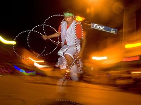 FILE - In this Aug. 12, 2010 file photo a hoop dancer wows the crowd in downtown Gallup, N.M. as part of the Gallup Inter-Tribal Indian Ceremonial night parade. Gallup surrounded by Navajo culture and Native arts and crafts is experiencing a tourism boom not seen since the 1970s.
