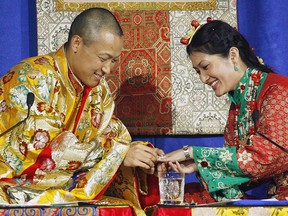 Sakyong Mipham Rinpoche, left, places a ring on his bride Princess Tseyang Palmo's finger during their Tibetan Buddhist royal wedding ceremony in Halifax on Saturday, June 10, 2006.